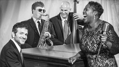 Adrian Duke Project The promotional photo formal with piano and sax