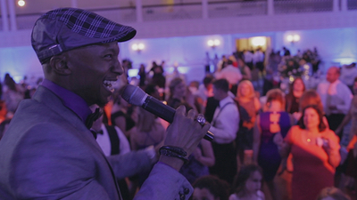 After Party Experience The male singer smiling and performing live for guests at a private event