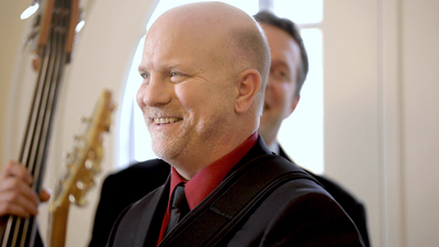 Alegria lead male singer smiling and entertaining guests