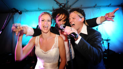 Dickens The bride and groom rock out on stage with singer