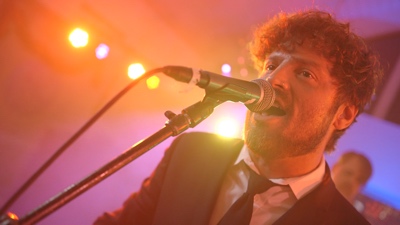 Dickens The male singer performing live for audience at a corporate event