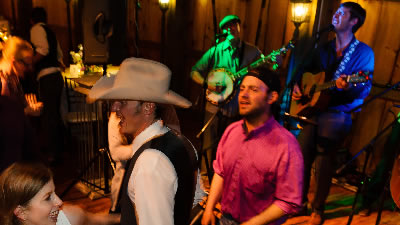 Gallatin Canyon guests dancing at a private wedding while band performs