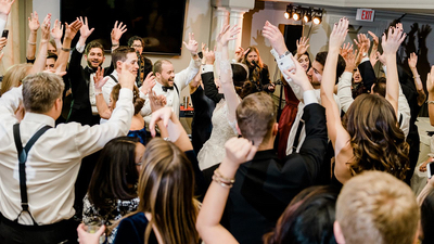 Finns The guests dancing at a wedding reception in a ballroom