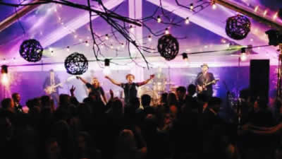 Free The guests dancing at a private wedding while band performs
